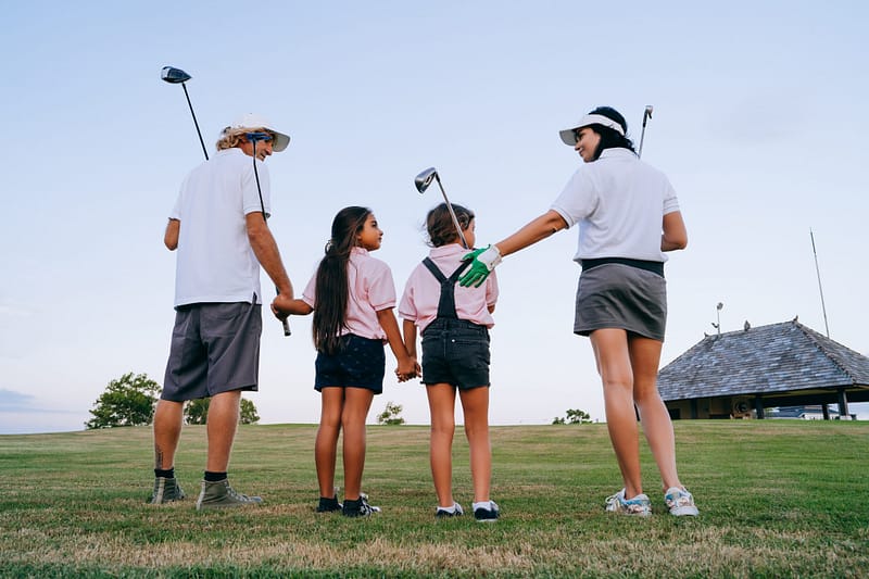 The Academy of Golf Dynamics a family at green golf course with golf items